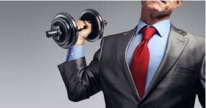 Businessman in suit raising dumbbell, business lawyer concept