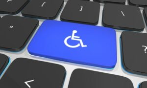 Disability wheelchair symbol on keyboard, website ADA rules concept