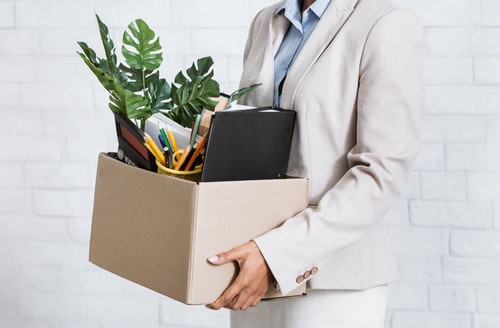 Businesswoman leaving company with box, concept of New York business law