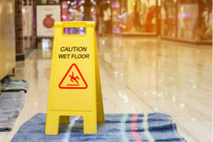 wet floor sign, premises liability defenses concept