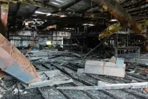 The interior of a building is charred from fire and requires a commercial property insurance claim.