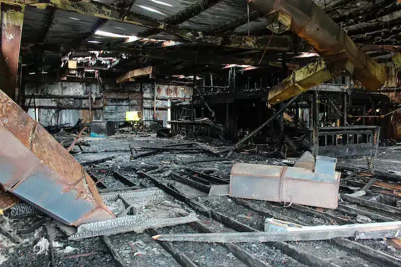 The interior of a building is charred from fire and requires a commercial property insurance claim.