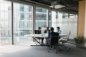 A team meets in a conference room to discuss commercial space for sale.