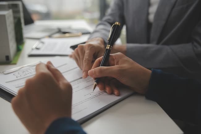 Stressed business person being pressured to sign unfair contract under duress showing coercion in New York business transaction