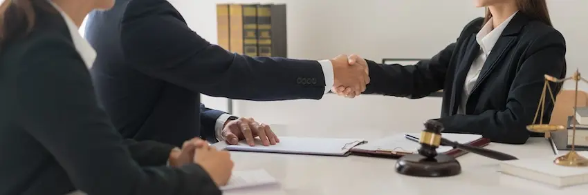 Business attorneys reaching a resolution on behalf of an insured client in an insurance coverage dispute